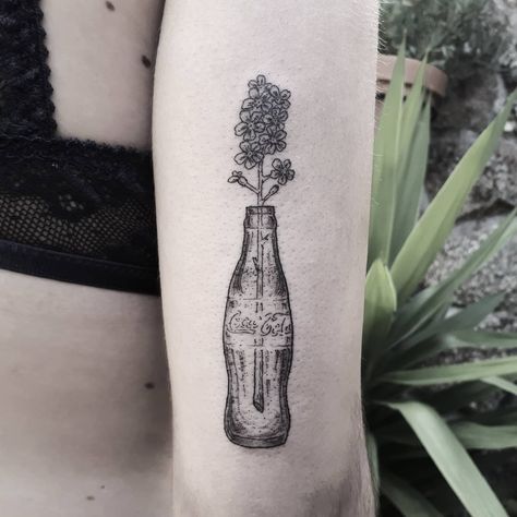 Black and grey tattoo of flowers in a Coca-Cola bottle inked on the back of the right upper arm Sister Friend Tattoos, Floral Tattoo Shoulder, Bottle Tattoo, Single Needle Tattoo, Cool Arm Tattoos, Cool Tattoos For Guys, Waves Tattoo, Elephant Tattoos, Grey Tattoo