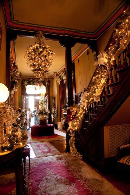 Lovely Victorian Christmas House Interior. Beautiful lit garland graces the wooden staircase, surrounded by traditional Victorian Era decorations, add charm to this old room Victorian Christmas Decorations, Independence Missouri, Historic Mansion, Christmas Interiors, Old Christmas, Victorian Christmas, Noel Christmas, Christmas Mood, Christmas House