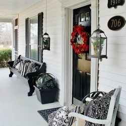 Black and White Farmhouse Front Porch Mini-Makeover. Red wreath is killer with the red flower window boxes. Long Front Porch Ideas Curb Appeal, Black And White Front Porch Ideas, Church Pew Front Porch, Black And White Porch Ideas, Long Front Porch Ideas, Black And White Front Porch, Long Front Porch Decorating Ideas, Rustic Farmhouse Front Porches, Farmhouse Front Porch Decorating