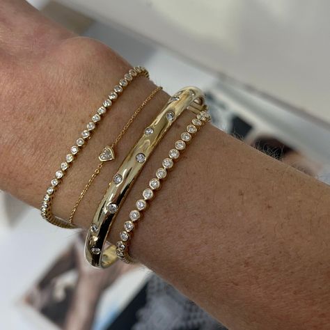 This sleek bangle captivates with scattering flush set diamonds set in 14k gold. Carefully crafted with comfort in mind, this bangle is easy to wear every day and a perfect addition to your stack if you're wanting to add more gold with a touch of sparkle! Available in 14k Yellow Gold, White Gold or Rose Gold Total Carat Weight: 1.75 cts Color: G/H Clarity: VS2 Closure: Hinge Made to order. Lead time is 4 weeks. Benefits of Solid 14k Gold Jewelry Most loved for its durability and longevity Can be Gold Bracket Stack, Gold Bracelet Stack, Gold And Diamond Bracelet, Flush Set Diamond, Stacked Bangles, Classy Jewelry, Gold Diamond Jewelry, Jewelry Lookbook, Stacked Jewelry