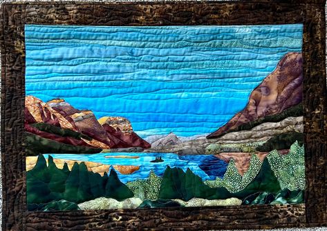 This is a wall quilt of Wild Goose Island at Glacier National Park.  Designed by Monique Kleinhans for Ladybug's Cabin Creations.  I bought the quilt kit when I was visiting Glacier this summer and enjoyed making this beautiful picturesque scene!  This measures 28" wide x 20" tall.  It has a rod pocket on the back for hanging with a curtain rod or dowel.  I free motion quilted it to accentuate the detail of the landscape.  I think it captures a small part of the beauty of Wild Goose Island! Landscape Quilts Tutorial, Impressionist Quilts, Fabric Landscapes, Quilt Landscape, Seascape Quilts, Embroidery Hacks, Collage Quilts, Patchwork Art, Fabric Panel Quilts