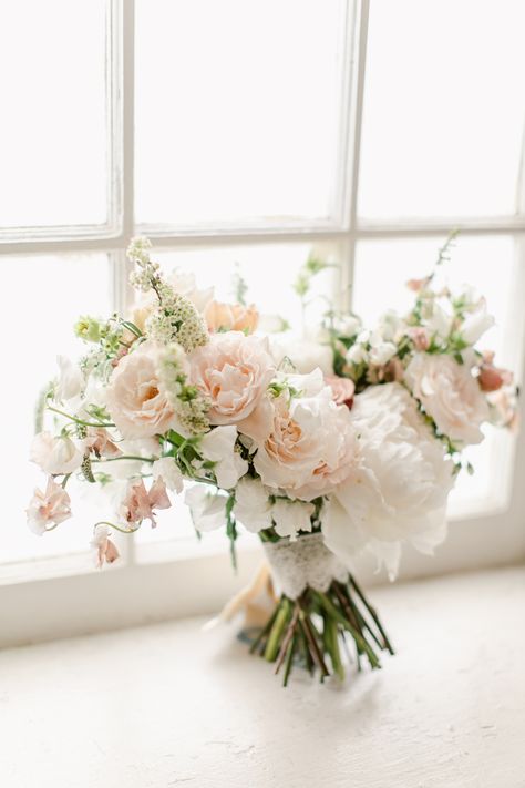 From the inspired hands of Doris Ione emerges a masterpiece: A bouquet interwoven with the softest hues of light pink and white, each petal and stem meticulously chosen to epitomize the pure essence of bridal grace, ensuring every bride feels as timeless as the love she celebrates. Light Pink Flowers Wedding, Light Pink Bouquet, Greenery Bridal Bouquet, White Bridal Flowers, Lifestyle Studio, Peach Bouquet, Pink And White Weddings, Light Pink Wedding, Bridal Bouquet Pink