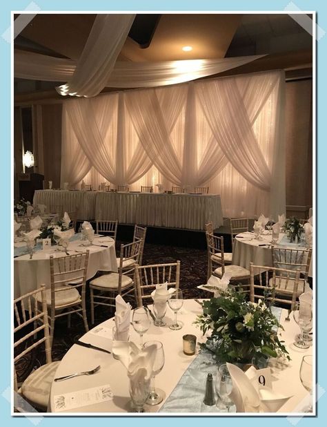 Cross Draping Wedding, Wedding Decor Ceiling Draping, Wedding Drapery Ideas Backdrops, White Drapes With Lights Wedding, White Curtain Wedding Backdrop, Head Table Draping Wedding, Wedding Backdrop Head Table Draping, Curtain Draping Ideas Backdrops, Wedding Backdrop Drapes