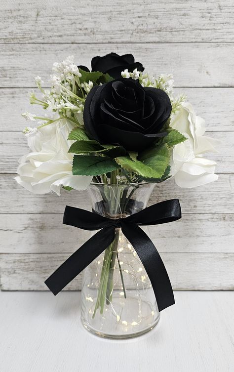 These beautiful centerpieces are perfect for your next event and include a glass vase with a set of warm white LED fairy lights, one black and white silk rose arrangement, and a black ribbon bow.  They are very popular for weddings, baby showers, parties, corporate events, holiday events, and any other event that requires table centerpieces. They also look great in any room of your house or office. To see other lighted jar options and all of my other listings, please view my shop: https://www.et Prom Tables Decorations, Elegant Black Table Setting, Red And Black Roses Centerpieces, Centerpieces With Cylinder Vases, Black And White Bridal Shower Centerpieces, Black White And Red Centerpieces, Men’s Birthday Table Decor, Simple Modern Centerpieces Wedding, Black White Burgundy Wedding Decor