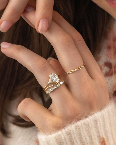 WHICH BAND WOULD YOU CHOOSE? We've styled our antique-inspired Lady's Slipper Ring with five wedding band options. 1. Curved Trio Band and Constancy Band 2. Rose cut diamond Plenilune Band 3. Curved Pairing Band and Prelude Band 4. Chevron Wisp Band 5. Curved Tinsel band Styling tip: When styling an engagement ring with a low basket setting that doesn't allow a band to slip underneath, add a simple band that has a customized curve to wrap around the engagement ring. Then add your favorite... Wedding Band Vs Engagement Ring, Curved Wedding Band Oval Engagement Ring, Curved Wedding Ring Stack, Contour Wedding Band With Oval Ring, Low Setting Engagement Ring With Band, Curved Wedding Band With Engagement Ring, Wedding Band With Oval Engagement Ring, Wedding Band Stack, Curved Wedding Ring