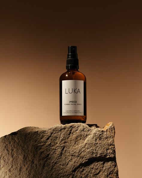 Promotional product photography of the product. Brown skincare spray LUCA Imber with toning facial spritz. Toner contains rosewater and cucumber. The product stands on a large brown stone, the sun creates a beautiful shadow in the background. Facial Product Photography, Product Beauty Photography, Product Photo Editing, Model With Product Photography, Best Product Photography, Skin Care Photography Products, Outside Product Photography, Product Photography Luxury, Beauty Products Photoshoot