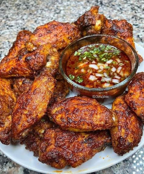 Mix together paprika, garlic powder, chili powder, salt and pepper. Pat dry chicken wings. Cover with spice mix. Marinate in refrigerator for at least 24 hours. Preheat refrigerator to 400\xc2\xb0F (200\xc2\xb0C). Cook for 30 minutes, then increase oven temperature to broil setting for 5-10 minutes. Serve with birria consomme: goat broth, diced onion, fresh lime juice, chopped fresh cilantro, tortillas and salsa. #ChickenWings #MexicanDishes Birria Wings, Sweet Chili Wings, Grandma Cooking, Fried Chicken Wings, Chicken Wing, Sweet Chili Sauce, Wing Recipes, Sweet Chili, Chili Sauce