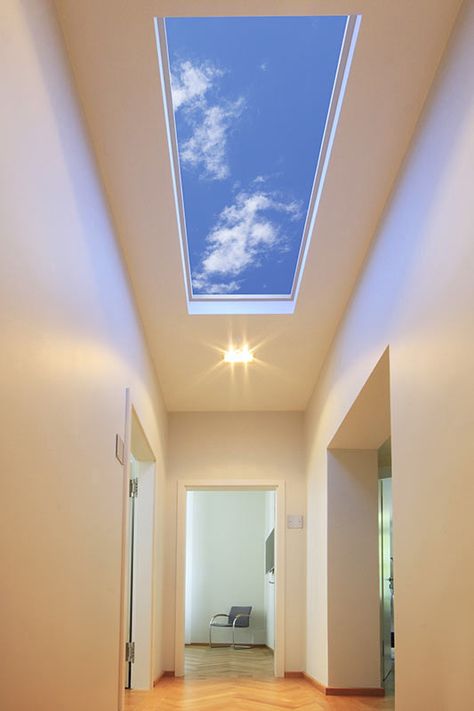 This stunning LED skylight from Sky Factory transforms interior hallways and other interior spaces into pleasant through ways by providing a pleasant connection to perceived open sky. Provide a visual connection to nature with Sky Factory's virtual skylights, Luminous SkyCeilings.  #artificialskylight #virtualskylight #ledskylight #fakeskylight Glass Ceiling Room, Transparent Ceiling Design, Skylight Entrance Hall, Sky Light Lighting, House With Skylight Ceilings, Artificial Skylight Ceilings, Coelux Skylight, Skylight Hallway, Virtual Skylight