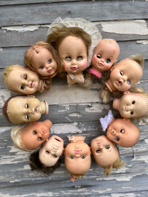 Creepy for Halloween! Indoor use only Doll Halloween Decorations Outdoor, Creepy Doll Halloween Yard, Doll Head Wreaths, Dolls Heads Ideas, Doll Head Crafts Halloween Decorations, Babydoll Head Planters, Doll Head Wreath Halloween, Doll Heads Crafts, Halloween Doll Display