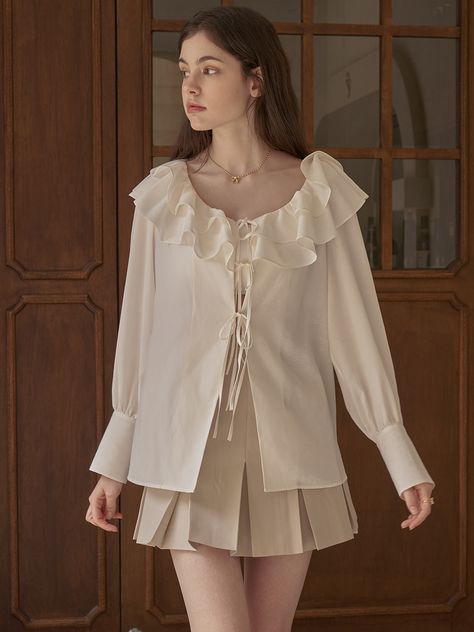 Editor's noteRomantic andluxurious mood blouse made of silky textured fabric. Featuring 2-layered ruffleneckline, 3 ribbons fastening at front, and buttoned cuffs. For the longoption, it has waist straps to fit your styling preferences, and you can tuckthe cloth inside the bottoms or pair with various items with short lengthbottoms like mini-skirt or shorts. For the cropped option, this will be theversatile item to pair with dress, skirts, and pants to form outfits in variousmood. - Ruffledneckl Blouse With Skirt, White Blouse Outfit, Form Outfits, Dress Skirts, Silky Top, Blouse Outfit, Textured Fabric, White Blouse, Diy Sewing