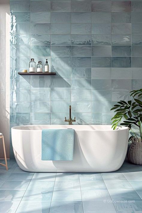 In this bathroom, the pale blue tiles bring a calming vibe, like a day by the sea. Bathroom Ideas Light Blue, Light Blue Tiled Bathroom, Bathroom Blue Floor, Bathroom Light Blue, Bathroom Tiles Blue, Blue Bathroom Ideas Decoration, Pastel Blue Interior Design, Blue White Bathroom, Coastal Blue Bathroom