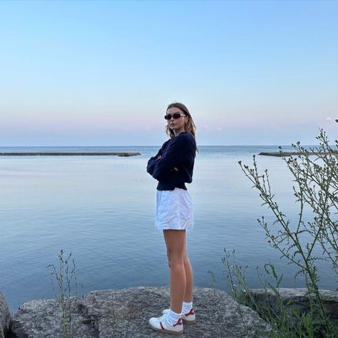 @allegrashaw wearing her Uncle Studios v-neck jumper on a walk by the water on a summer night