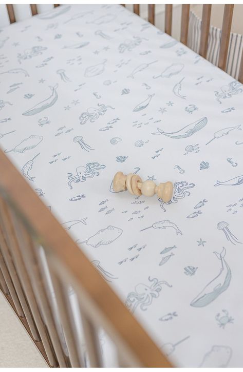 Perfect for a neutral nursery, this darling crib sheet patterned in sweet bunnies is woven from supersoft brushed organic cotton to keep baby comfy. 100% organic cotton Machine wash, tumble dry Imported Kids' Wear Coastal Crib Sheets, Marine Themed Nursery, Coastal Boys Nursery, Nautical Decor Nursery, Ocean Themed Baby Room, Baby Boy Beach Nursery, Sage Green And Blue Nursery, Beach Boy Nursery, Ocean Themed Nursery Boy