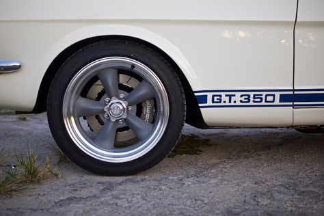 This is production car #45, a Revology 1966 Shelby GT350 in Wimbledon White with Guardsman Blue LeMans stripes, on its way to its new home in Canada.  This car has the iconic Shelby white and blue color combination and looks very authentic, but when you look closely you will notice its 460hp Ford Gen 3 Coyote 5.0 engine, 6-speed manual transmission, 8.8" rear with 33 spline axles, and twin disc clutch. 1966 Shelby Gt 350, Shelby Mustang Gt500 1967, 67 Shelby Gt 500 Eleanor, Light Blue Mustang, Blue Color Combinations, Twin Disc, 1968 Shelby Mustang Gt500-kr, Old Muscle Cars, Shelby Gt