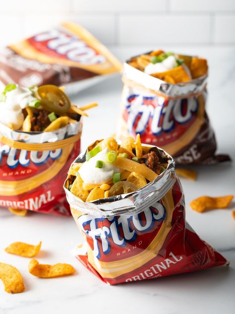 The Best Frito Chili Pie - An easy recipe for classic Frito pie made with flavorful beef chili and corn chips! Perfect to serve in a bowl or right in the bag with shredded cheese and all your favorite toppings. We love this as a camping meal recipe: just prepare the chili ahead of time, reheat over the campfire, and stuff the Fritos bags on the spot! | A Spicy Perspective Frito Pie In A Bag, Walking Meals, Frito Chili Pie Recipe, Chili Pie Recipe, Rv Meals, Frito Pie Recipe, Frito Chili, Frito Chili Pie, Chili Pie