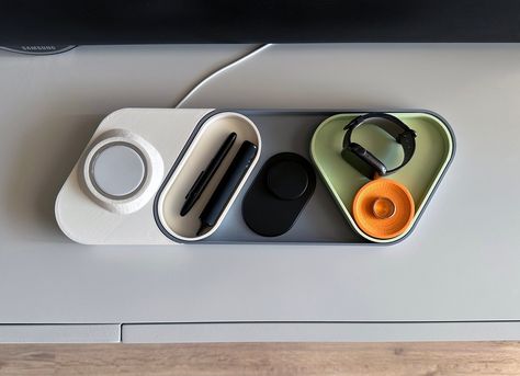 Declutter your desk or have a single place to store all of your daily essentials with this modern, modular & colourful catchall tray and desk organiser with an optional MagSafe charger add-on.  🎨 Printed from recycled PLA plastic you can choose from the following colour accents:  - Sunrise Orange/Mint - Sapphire Blue/Ice - Rose/Sakura Pink - Black/Black WHAT'S INCLUDED? ℹ️ If you purchase only the tray you'll get:  - 1x main tray in gray - 1x triangular tray in the accent colour of your choice - 1x oval tray in white  - 1x circular tray in the accent colour of your choice ℹ️ If you purchase the tray & the MagSafe add-on you'll get: - 1x main tray in gray - 1x triangular tray in the accent colour of your choice - 1x oval tray in white  - 1x circular tray in the accent colour of your choice Modular Desk Organizer, Modern Product Design, Modern Desk Decor, Unique Desk Organizer, Ice Rose, Desk Organizer Tray, Sunrise Orange, Desk Items, Drukarka 3d