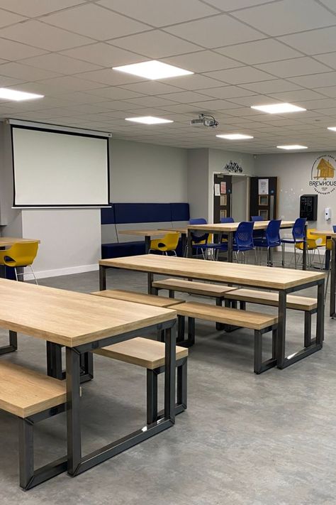 Sixth Form College common room furniture installation featuring various soft seating, bench tables, and stools. The Ferro bench table is an industrial styled bench table with oak effect surface. #college #academia #collegefurniture #furniture #canteenfurniture #canteen #canteendesign #fitout #furniturefitout #refit #refurbish #installation #furnitureinstallation College Furniture Design, Common Room Ideas College, Common Room College, School Benches Design, Canteen Design Ideas, College Common Room, Work Canteen, Communal Table Design, College Canteen