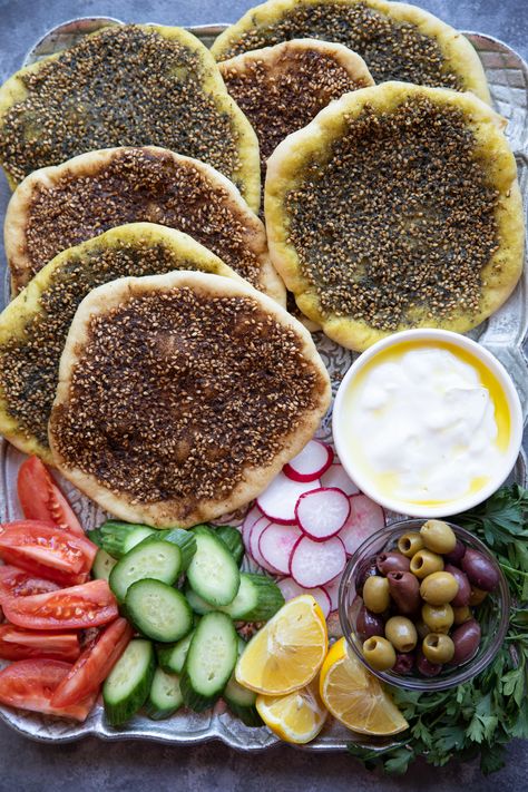 Manakish zaatar is a classic Middle Eastern flatbread topped with olive oil and zaatar spice. Zaatar is a combination of spices and has a wonderful earthy flavor. This bread is so easy to make and is perfect for breakfast with some cheese! Learn how to make this simple Middle Eastern vegan bread with just a few ingredients, you're going to love it! Middle Eastern Brunch Ideas, Dinner Party Middle Eastern, Middle Eastern Feast, Middle East Breakfast, Zaatar Bread Recipe, Manakish Recipe, Zaatar Bread, Middle Eastern Breakfast, Arabic Breakfast