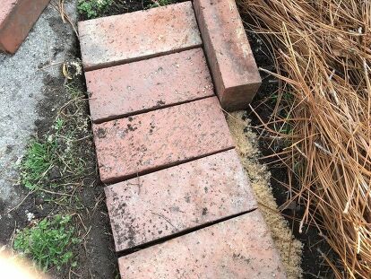 Repurposing leftover brick into lovely garden edging has never been easier. Find out how to complete this weekend project! Apparently, I like structure, and this flower bed seemed to be spilling out onto the lawn. Lucky for me, old patio bricks were stacked onto a pallet in the backyard and were waiting to be used. The project of creating the brick garden edging took a weekend, but I wasn’t working full days. Here’s what you’ll need to complete the project.Bricks (how many depends on… Diy Brick Planters Outdoor, Yard Pergola, Brick Flower Bed, Paver Sand, Brick Border, Brick Garden Edging, Garden Spade, Brick Edging, Landscape Borders