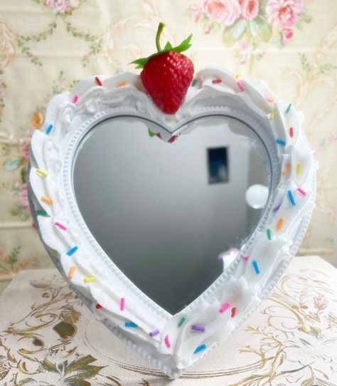 White Heart Faux Cake Mirror topped with a strawberry & sprinkles: This Faux Caked Up mirror is visually appealing with delightful style with an inviting display. This heart shaped mirror can sit on a desk, vanity, hang on a wall or used for selfies fit for an any Queen!    Ultimately, it is more than just a sweet gift/ prop- it is a sensory experience that delights the eye and leaves a lasting impression of decadent pleasure,  fit for any special occasion to last a lifetime with proper care. Di Kids Mirror, Eclectic Boho Bedroom, Kids Mirrors, Micro Pigs, Heart Mirror, Boho Eclectic, Fake Cake, Caking It Up, Furniture Vanity