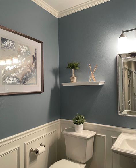 Blue bathroom with wainscoting and crown molding Bathroom Blue And Grey, Country Blue Bathroom Ideas, Bathroom 2 Color Walls, Light Blue Wall Bathroom, Greyish Blue Bathroom, Bathroom Inspo Wall Color, Light Blue Walls With Accent Wall, Blue Grey Paint Bathroom, Restroom Wall Color Ideas