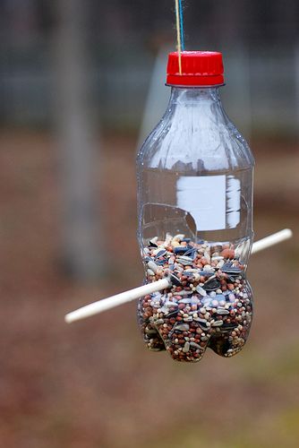 coke bottle bird feeder | Coke bottle bird feeder | Flickr Diy Bird Feeders Homemade, Homemade Bird Feeder, Make A Bird Feeder, Bird Feeder Craft, Backyard Getaway, Homemade Bird Feeders, Bird House Feeder, Diy Bird Feeder, Diy Birds