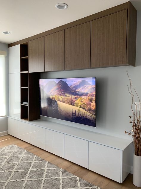 Two-tone TV wall with 75” TV.  White gloss panel from Europe and Canadian laminate wood grain. Tv Wall White Wood, Besta Tv Wall Unit, Tv Cabinet White And Wood, Living Room Laminate Ideas, White And Wood Tv Wall, White And Wood Tv Unit, Tv Cabinet Design White, Besta Tv Wall Ideas, Tv Wall With Wood Panels