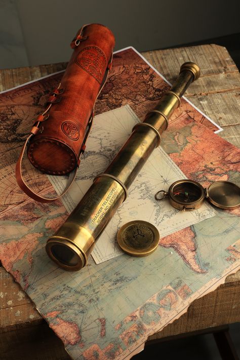 On order you get a rare working replica of an East India Company 1818 brass telescope . It's hand crafted in premium quality brass and fitted with high resolution optical lenses for great magnification. When stretched this brass telescope measures 32 inches and when collapsed it's merely 12 inches that makes it fit for easy storage and carrying. Comes in a hand stitched Leather case that has detailed markings and can be used as a carry case as well. Almost 900 gms weight approximately. High Resolution Optical DF Lens provide brilliant magnification in this large brass telescope Heavy & LARGE Telescope spyglass Measure 32 inches when stretched and 12 inches when collapsed. Spyglass Aesthetic, Fantasy Telescope, Telescope Reference, Inventor Aesthetic, Telescope Aesthetic, Old Telescope, Telescope Decor, Small Telescope, Pirate Telescope