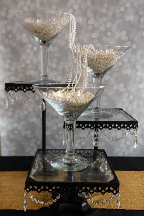 These DIY Gatsby party centerpieces are awesome! I love the ones made with ostrich feathers and the champagne glass tower. A perfect addition to my roaring 20s party decor. #entertainingdiva #roaring20s #gatsbywedding #centerpieces #partydecor #diypartydecor Champagne Glass Tower Gatsby Party, Gatsby Party Ideas 1920s, The Great Gatsby Centerpieces, 1920s Party Centerpieces, 1920s Centerpieces Roaring 20s, 20s Decorations 1920s Party, End Of My Roaring 20s Party, The Great Gatsby Decorations, 20s Party Centerpieces