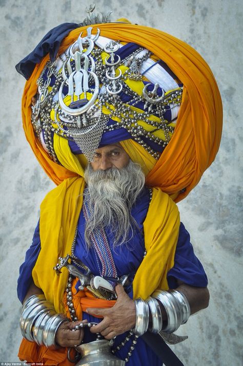 Avtar Singh is seen wearing a huge traditional Punjabi turban called 'pagdi' in the Indian town of Patiala on July 19 in Punjab. The impressive headgear weighs a hefty 100lbs and measures in at a staggering 645m when unwrapped - the same as 13 Olympic-sized swimming pools. The 60-year-old has been regularly adding to it for the past 16 years and it can take him up to six hours to put it on. His supersize turban made him one of the most respected preachers in the Pubjab, but it causes day-to-day Yoga Studio Design, Amazing India, We Are The World, Cultural Diversity, Varanasi, World Cultures, People Of The World, Turbans, Incredible India