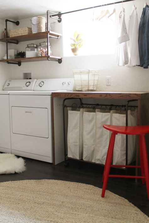 basement laundry room -- I like the simplicity of this room, the wooden folding table, the shelves over the washer/dryer, the drying rack, the laundry sorter under the table (genius, then you don't have to see the messy laundry!), and the bright red stool Functional Basement, Laundry Room Organization Storage, Room Storage Diy, Casa Clean, Basement Laundry Room, Basement Laundry, Farmhouse Laundry Room, Small Basements, Laundry Room Remodel