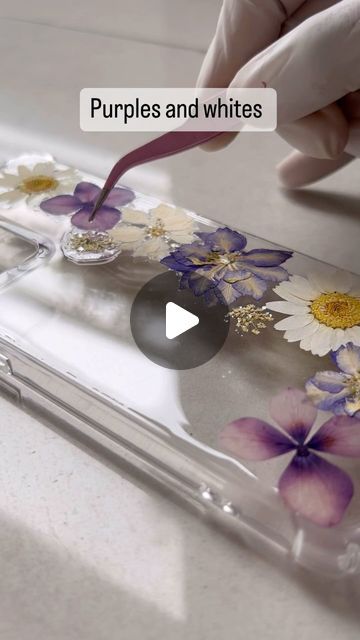 ख्वाबिदाह् on Instagram: "You ask, and I deliver.

Made a mobile cover consisting white and purple flowers as the customer wanted. 

Dm to order. 
Customisation available. 
Available for all mobile phones. 

Resin from - @resincult (A lot of you keep asking me for which resin I use. It can’t get said enough. It’s them and only them. They have the best resin to work with on any kind of project. ) 

#khwabidah #resinart #pressedflower #driedflowers #mobileaccessories #mobilecover #accessories #mobile #resinmobilecover #flower #flowers  #daisy #larkspur" Resin Phone Cover, Resin Mobile Cover, White And Purple Flowers, Make A Mobile, Flowers Daisy, Accessories Mobile, Mobile Cover, All Mobile Phones, Mobile Covers