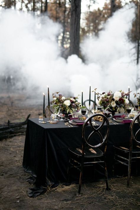 Dark and moody wedding reception tablescape with black table cloth, dark purple tapered candles,and burgundy and white floral centerpieces.| Moody Jewel-Toned Halloween Wedding Inspiration Shoot | #equalitymindedweddings #lgbtweddingmagazine #loveinc #halloweenwedding #halloween #floralcenterpiece #moodyweddingphotography Ballet Wedding, Moody Wedding Photography, White Floral Centerpieces, Dark Wedding Theme, Gothic Floral, Halloween Themed Wedding, Reception Tablescapes, Unique Wedding Flowers, Goth Wedding