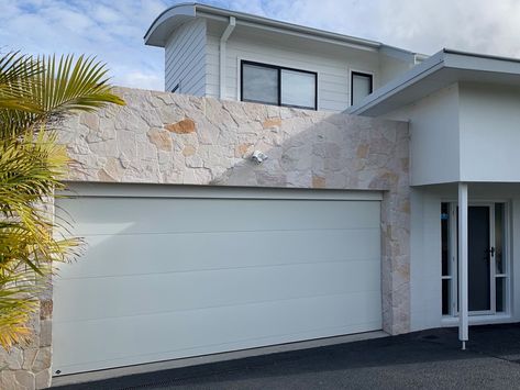 white garage door on modern home with stonework White Garage Doors, White Garage, Modern Minimalist Home, Stone Work, Garage Door, Minimalist Home, Modern Minimalist, White House, The Modern