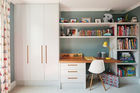 Study in the contemporary kids’ room with ample storage and shelf space Suitcase Bookshelf, Kids Study Room Ideas, Contemporary Kids Room, Study Room Ideas, Homework Space, Bookshelf Chair, Blue Suitcase, Built In Cupboards, Yellow Table