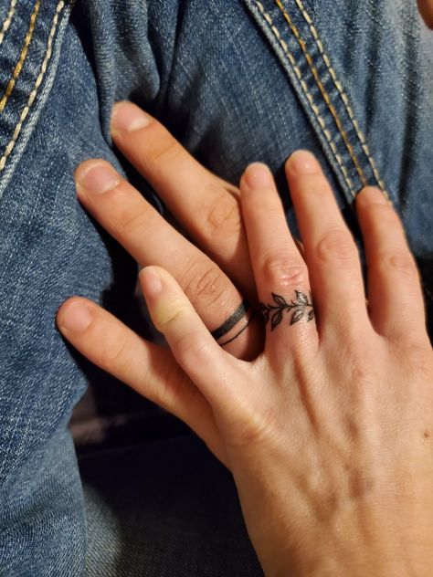 Married Ring Finger Tattoos, Rings Tattoo Wedding, Wedding Band Tattoo Couples Initials, Wedding Band Tattoo With Ring, Name Tattoo Ring Finger, Tattoo Ring Designs, Leaf Wedding Ring Tattoo, Wedding Tattoos Finger Men, Wings On Finger Tattoo