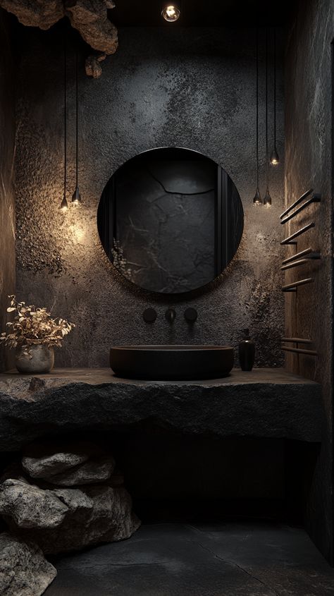 Modern bathroom featuring a black matte stone sink, round mirror, and dark grey wall with natural rock and textured tiles. Stone Bowl Sink Bathroom, Dark Sink Bathroom, Modern Dark Bathroom Design, Black Stone Bathroom, Wabi Sabi Toilet, Stone Bathroom Ideas, Dark Bathroom Aesthetic, Black Stone Wall, Stone Sink Bathroom