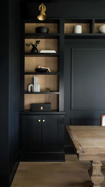 Kelly Jones on Instagram: "Want to enhance the look of a built-in? We added some leftover white oak hardwood flooring to the back of our moody office but-ins. This added contrast, texture and a great backdrop for the shelf decor. 🤗

#beforeafter #interiorismo #office #homeoffice #remodel #homesweethome #homedesign" Men’s Office Built Ins, Bookshelves Modern Design, Built In Shelves Office Bookshelves, Black Office Built Ins With Desk, Black Office Bookshelves, Office With Black Built Ins, Lighted Bookshelves Built Ins, Black Built Ins With Wood Shelves, Built In Wall Of Cabinets