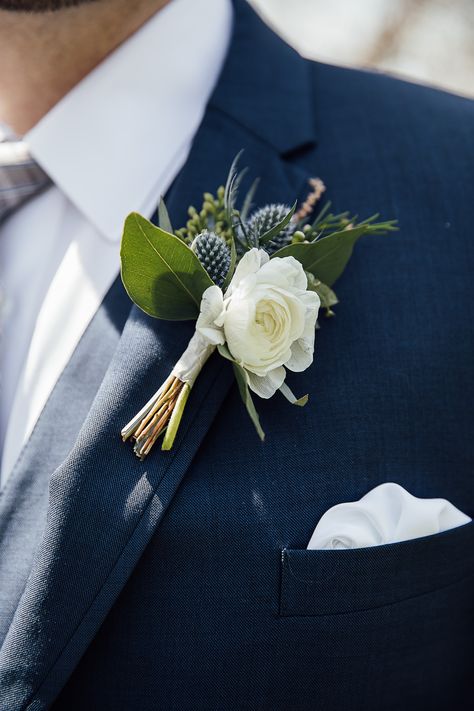 This blue thistle boutonniere with a white flower looked great on this groom's navy suit. Blue Thistle Boutonniere, Whimsical Spring Wedding, Thistle Boutonniere, Winter Wedding Destinations, The Mother Of Dragons, Memphis Wedding, Blue Thistle, Nashville Wedding Venues, Contemporary Bride