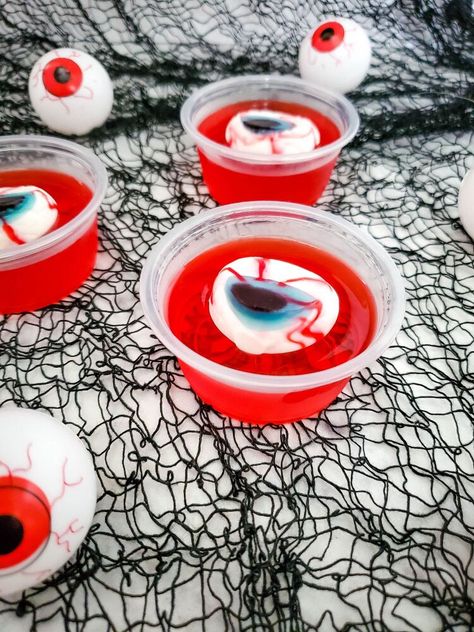 Eerie! Spooky! Wacky! These are just some of the expressions your guests should have this coming Halloween. Nothing on the menu will achieve that expression as compared to these Eyeball Jello Shots. These deliciously boozy treats are perfect for a spooky Halloween party.Making these Eyeball Jello Shots is surprisingly easy and straightforward. However, note that the recipe includes alcohol and is not fit for kids. By now, you probably have a lot of questions concerning the Eyeball Je… Adams Family Snacks, Hello Shots Halloween, Halloween Jello Ideas, Easy Halloween Food Recipes, Eyeball Jello, Halloween Jello Shots, Pelottava Halloween, Halloween Jello, Boozy Treats