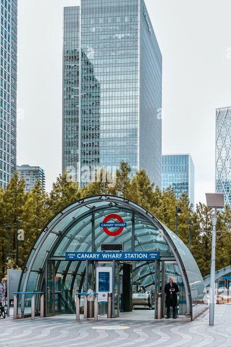 Curved glass canopy of Canary Wharf Underground station with high rise buildings in the background including JP Morgan, Newfoundland & 40 Bank Street. High Rise Buildings, Jpmorgan Chase & Co, Glass Canopy, Jp Morgan, Underground Station, Street Stock, Canary Wharf, High Rise Building, Curved Glass