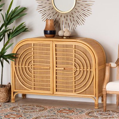 Refresh the potential of your space with the exotic grace and versatility of the Esopus sideboard. Made in Indonesia, this bohemian piece is handcrafted from natural rattan. The doors open to reveal two spacious shelves perfect for organizing a variety cookware and other utensils. The Esopus will arrive fully assembled and features woven rattan door fronts embellished with a smooth geometrical design for an eye-catching display. Exuding tropical elegance, the Esopus sideboard invigorates the moo Retro Bohemian Decor, Sedona House, Bohemian Decor Bedroom, Homecoming 2023, Rattan Sideboard, Single Lady, Eclectic Cottage, Bohemian Furniture, Wide Sideboard