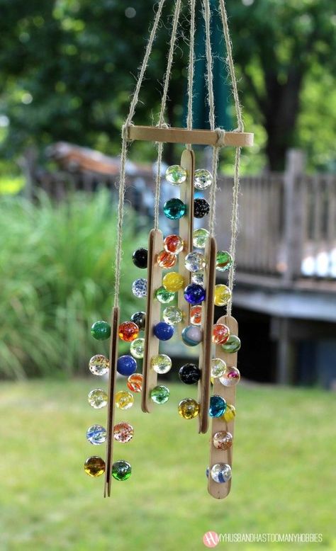 This is a fun craft the you can do with the kids using just a few supplies that you may already have on hand like we did.   My son wanted to create something using his small marble collection, so we looked in our craft box and pulled out some craft sticks and got busy making this fun sun catcher.    He selected the marbles he wanted to use and glued 5 marbles on 10 craft sticks using 527 Glue.   We left them to dry overnight.  The next day we glued two craft sticks together with a long… Marble Suncatchers, Suncatcher Mobile, Backyard Table, Crystal Suncatchers Diy, Flat Marbles, Light Up Canvas, Marbles Crafts, Easy Fall Wreaths, Fun Fall Crafts