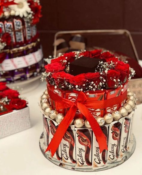 Chocolate Tower..... ❣️ Dm for orders @crafting_with_zana #Chocolatetower#chocolatehamper#crafts#engagement#wedding#love#giftideas#chocolate#hampers#flowerdecor#happiness#diy#diyideas#engajamentoinsta#weddinggifts#instapicframes#share#like#follow#affordable#price#moments Engagement Kavidi Ideas, Chocolate Hamper Ideas Gifts, Engagement Arrangements, Shagun Thali, Chocolate Tower, Diy Hair Accessories Tutorial, Wedding Hampers, Candy Bar Bouquet, Gubahan Hantaran