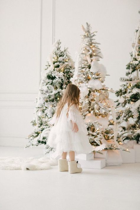 White and gold Christmas wonderland shoot | 100 Layer Cakelet | Bloglovin’ White Christmas Set Photography, Christmas Decor Ideas For Photoshoot, White Christmas Photography, White Christmas Studio Photography, White Christmas Mini Sessions, Christmas Photo Decor, Christmas Minis Studio, White Christmas Photo Shoot Family, White Christmas Family Photoshoot