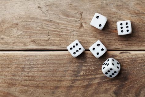 The dollar game isn't won on skill or expertise. It's purely a game of luck with the dice determining each play. A minimum of three players with three dollars each is needed to start the game. The dice is rolled, and each player makes a move depending on the number of pips facing up. Dollar Game, Card Table And Chairs, Table Top View, Reunion Games, Wooden Table Top, Gambling Games, Good Day Song, Dice Games, Poker Chips