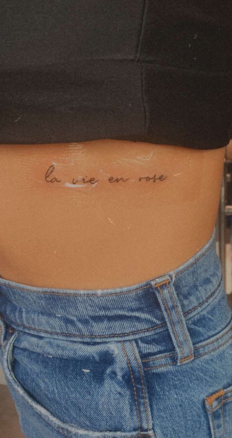 la vie en rose, himym, how i met your mother, tattoo, small, small tattoo, ti t, tiny tattoo, rib tattoo, side boob tattoo, french, life in pinm, france, ink, tattooinspo, inspo, small tattoo inspo Paris Tatoos, Small Tattoos Women Arm, La Vie En Rose Tattoo Fonts, Cute French Tattoos, France Inspired Tattoo, Tattoo Ideas French, Small Tattoos Ribcage, French Tattoos For Women, Paris Tattoo Small