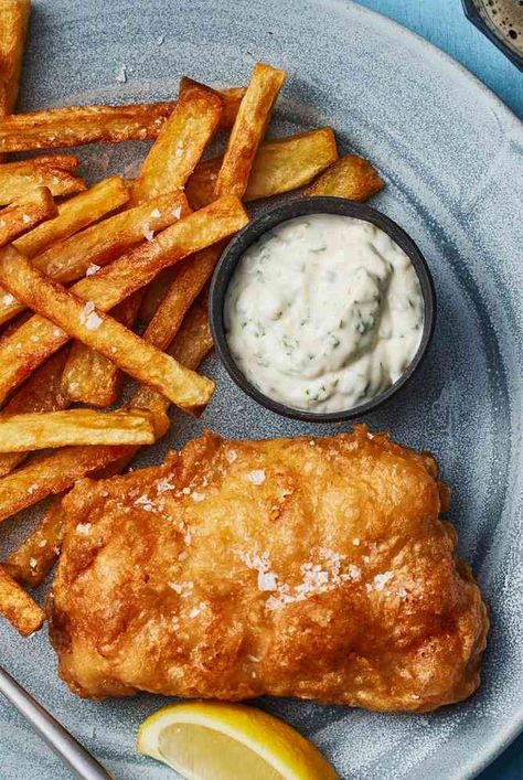 Make classic British fish and chips at home with this recipe, which includes fried cod, tartare sauce, triple-fried french chips, and mushy peas. Homemade Fish And Chips, British Fish And Chips, Pub Night, Fish Batter Recipe, Fish N Chips Recipe, Fried Cod, Mushy Peas, Night At Home, Chips Recipe