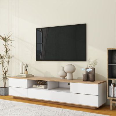 Modern TV stand with multi-functional storage keeps your TV area neat and organized. Whether you use your TV in your living room, bedroom, or entertainment room, this TV stand will meet your storage needs. Not only does it accommodate TVs up to 80 inches, but it also offers plenty of storage space to make your life easier. Color: White | Fu Owner 70.8" W Storage Credenza Wood in White | 16.1 H x 70.8 W x 15 D in | Wayfair Wood And White Tv Stand, Miami Living Room Decor, White And Wood Tv Stand, 70 Inch Tv In Living Room Ideas, Living Room Decor Tv Stands, Living Room White And Wood, Tv Area In Bedroom, White Tv Stand Living Room, Tv Stands Ideas For Living Room