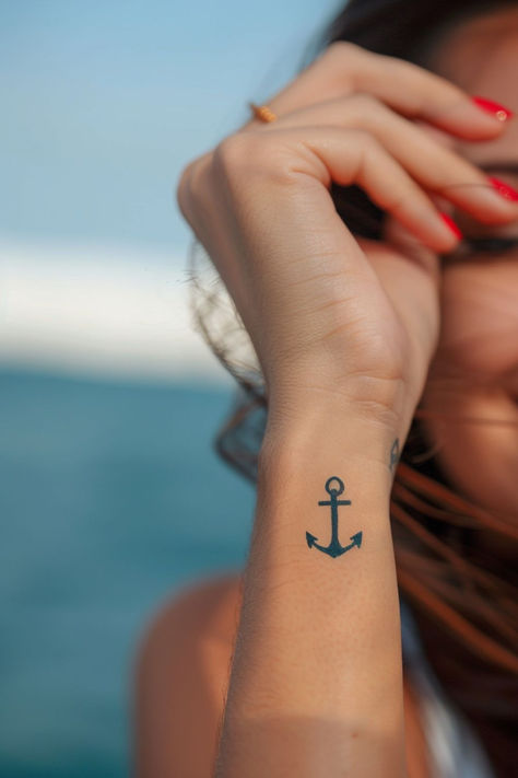 Looking for stunning wrist tattoo design ideas?! This anchor wrist tattoo is TOO gorgeous. From subtle and elegant to bold and creative, find the perfect wrist tattoo to match your style. Anchor Tattoo Placement For Women, Anchor Tatoos Woman, Anchor Tattoo Designs For Women, Hope Anchor Tattoo, Anchor Wrist Tattoo, Fineline Anchor Tattoo, Navy Anchor Tattoos For Women, Compass Anchor Tattoo Design, Small Anchor Tattoos For Women